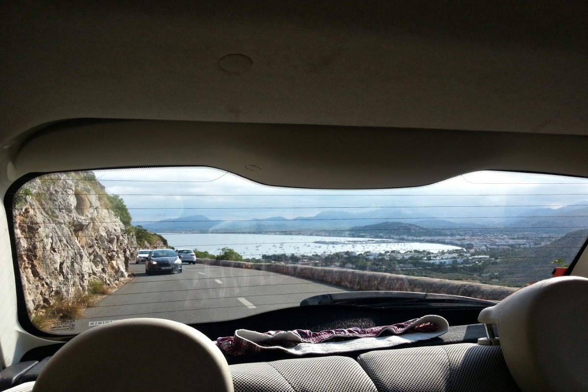 rear window car window spain mallorca coastal landscape drive